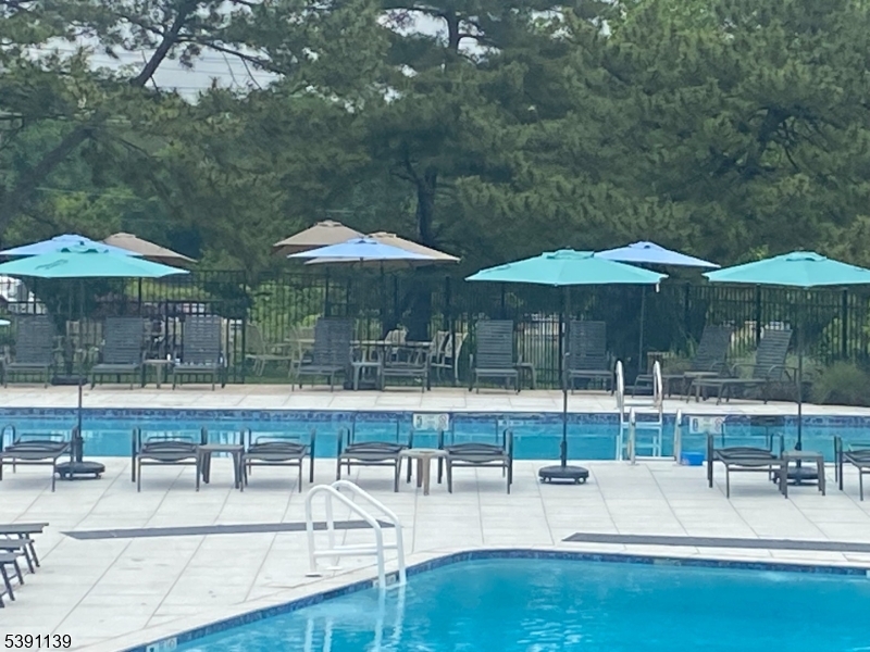 824 Main Street, Unit J Belleville, NJ 07109 - Photo 20 of 24 a view of a swimming pool with chairs in patio