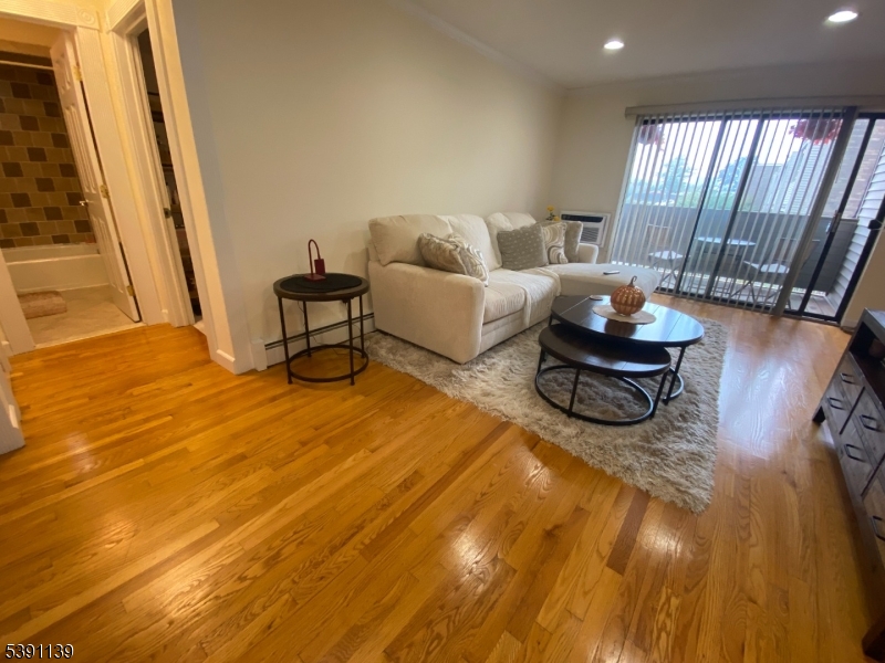 824 Main Street, Unit J Belleville, NJ 07109 - Photo 2 of 24 a living room with furniture and a rug