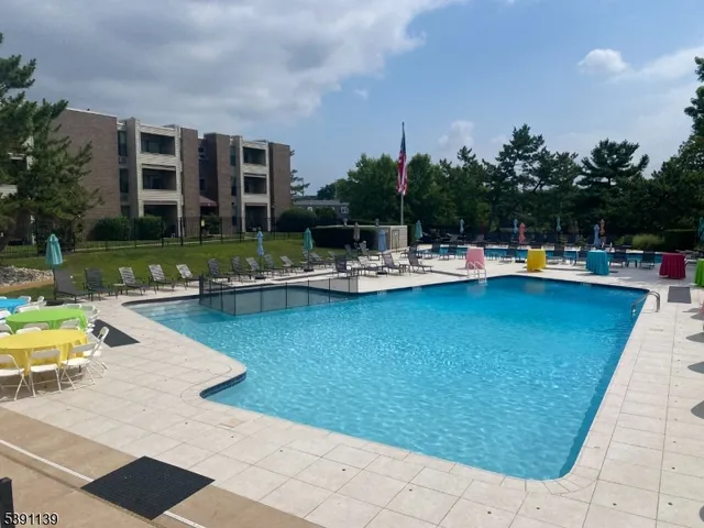 a view of a swimming pool with outdoor seating and plants