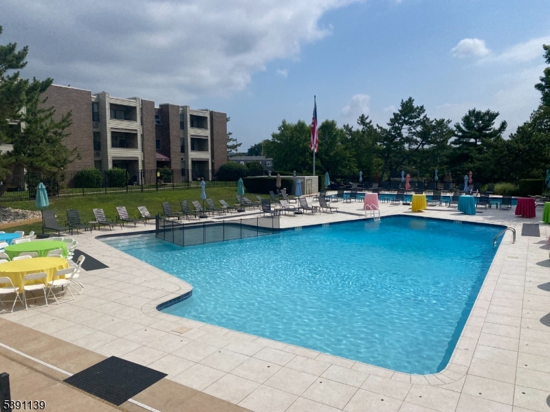 824 Main Street, Unit J Belleville, NJ 07109 - Photo 21 of 24 a view of a swimming pool with outdoor seating and plants