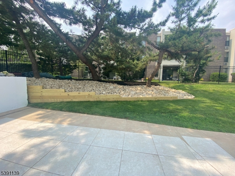 824 Main Street, Unit J Belleville, NJ 07109 - Photo 22 of 24 a view of a yard with plants and large trees