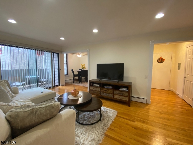 824 Main Street, Unit J Belleville, NJ 07109 - Photo 3 of 24 a living room with furniture and a flat screen tv