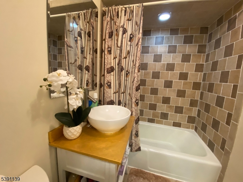 824 Main Street, Unit J Belleville, NJ 07109 - Photo 5 of 24 a bathroom with a sink toilet and shower