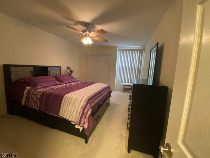 824 Main Street, Unit J Belleville, NJ 07109 - Photo 7 of 24 a bedroom with a bed and a chandelier