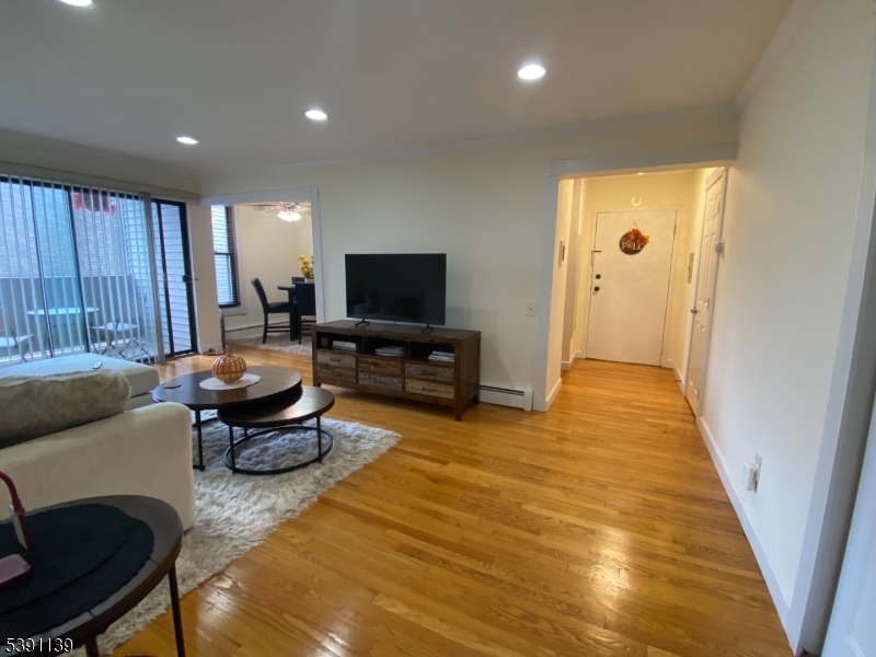 824 Main Street, Unit J Belleville, NJ 07109 - Photo 8 of 24 a living room with furniture and a flat screen tv