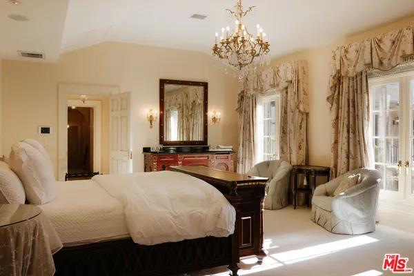 a bathroom with a double vanity sink a mirror and a bathtub