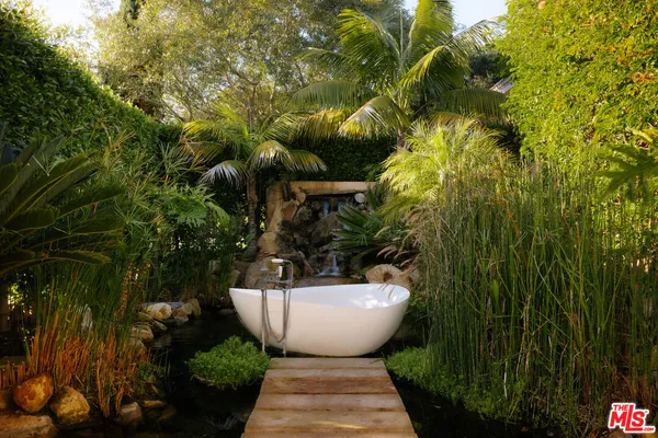 an aerial view of a house with a yard and lake view