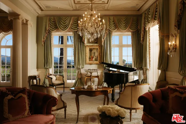 a living room with furniture and large windows