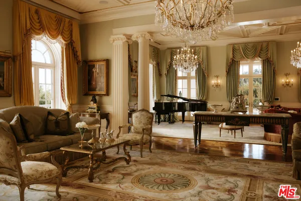 a living room with couches and a dining table with wooden floor