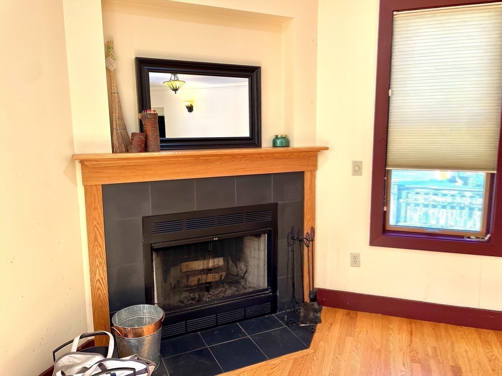 30 Landy Avenue Northampton, MA 01062 - Photo 8 of 40 a living room with a fireplace and a large window