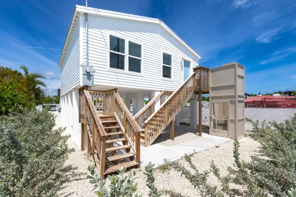 a view of a house with wooden stairs