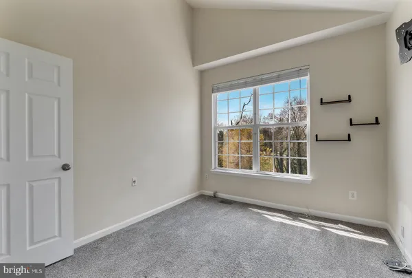 an empty room with windows and closet