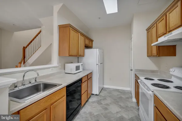 a kitchen that has a sink and a stove