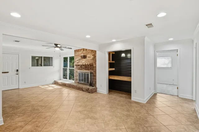 a view of a livingroom with a ceiling fan and window