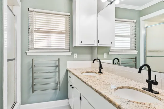 a kitchen with granite countertop a sink stainless steel appliances and cabinets