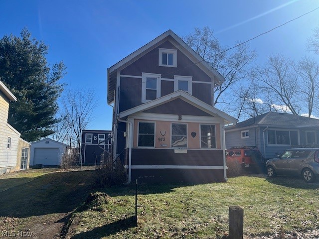 973 Nevin Street Akron, OH 44310 - Photo 1 of 19 Traditional style home with a front yard, a garage, and an outdoor structure