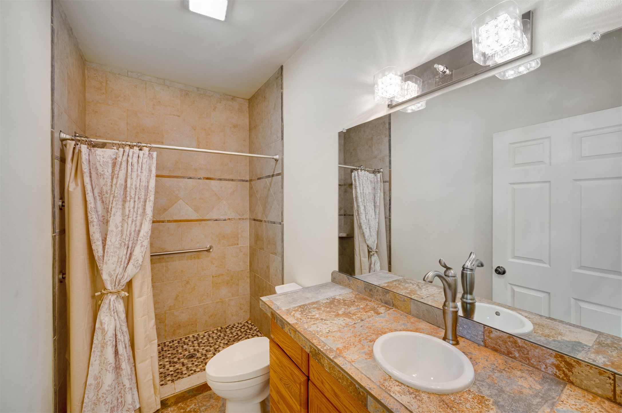 531 County Road 3501 Cuney, TX 75759 - Photo 31 of 45 a bathroom with a granite countertop sink toilet a mirror and shower