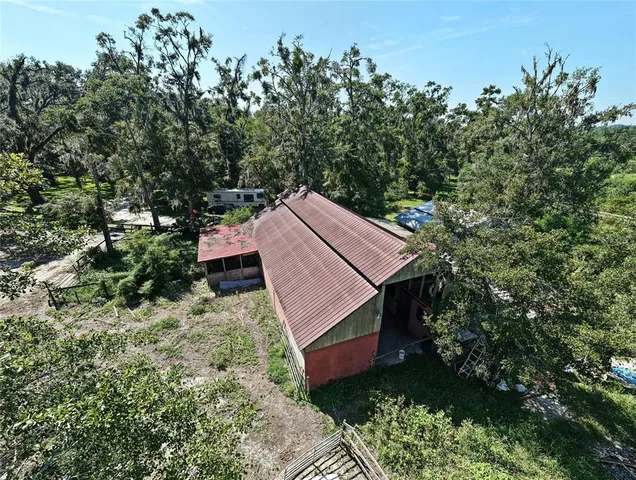 a view of a yard with large trees