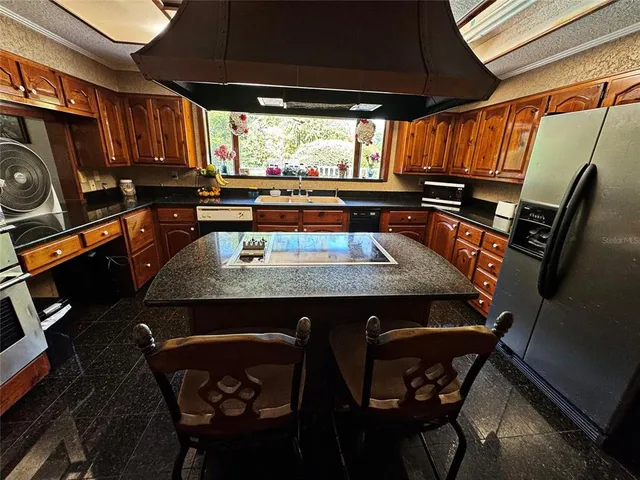 a dining room with a sink and wooden floor