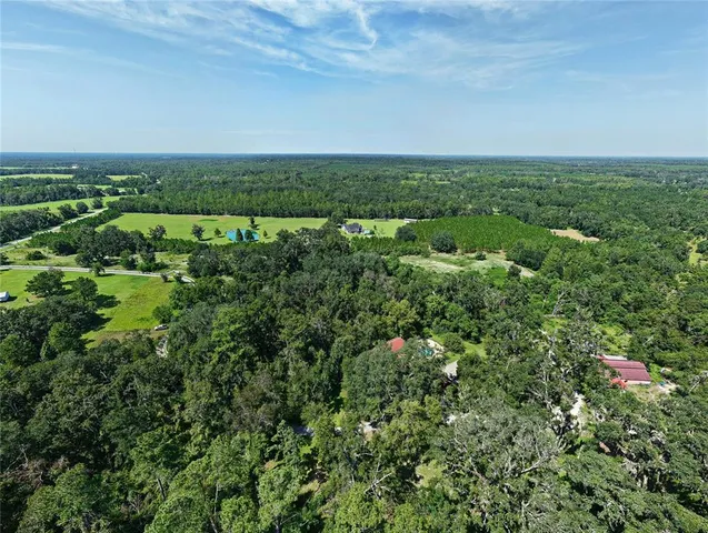 an aerial view of a city with lots of residential buildings and mountain view in back