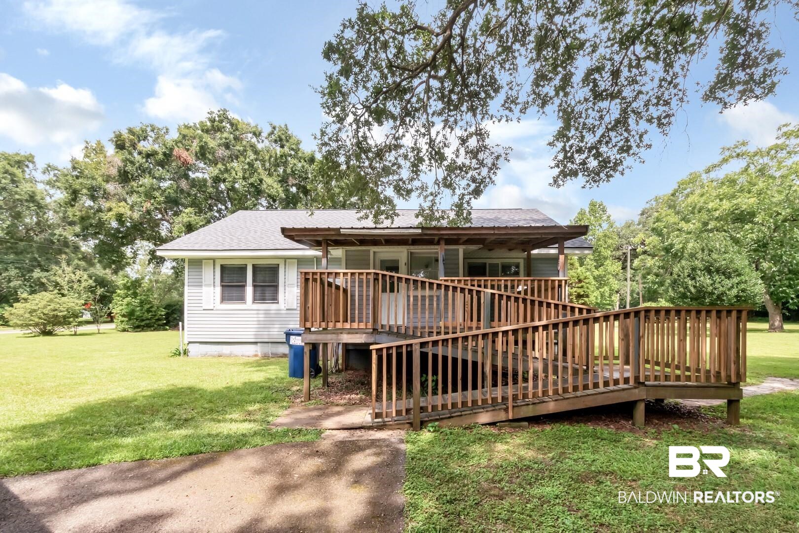 12751 Zanzibar Road Grand Bay, AL 36541 - Photo 19 of 30 View of front of home with a deck and a front lawn