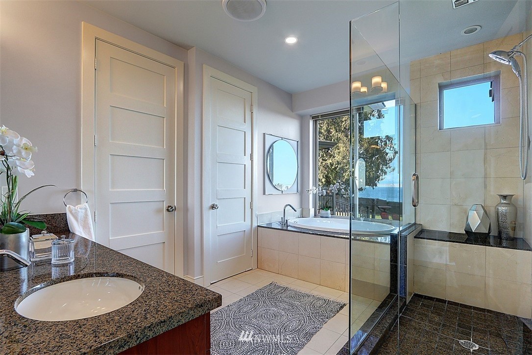 16912 Talbot Road Edmonds, WA 98026 - Photo 16 of 40 a bathroom with a tub sink and mirror