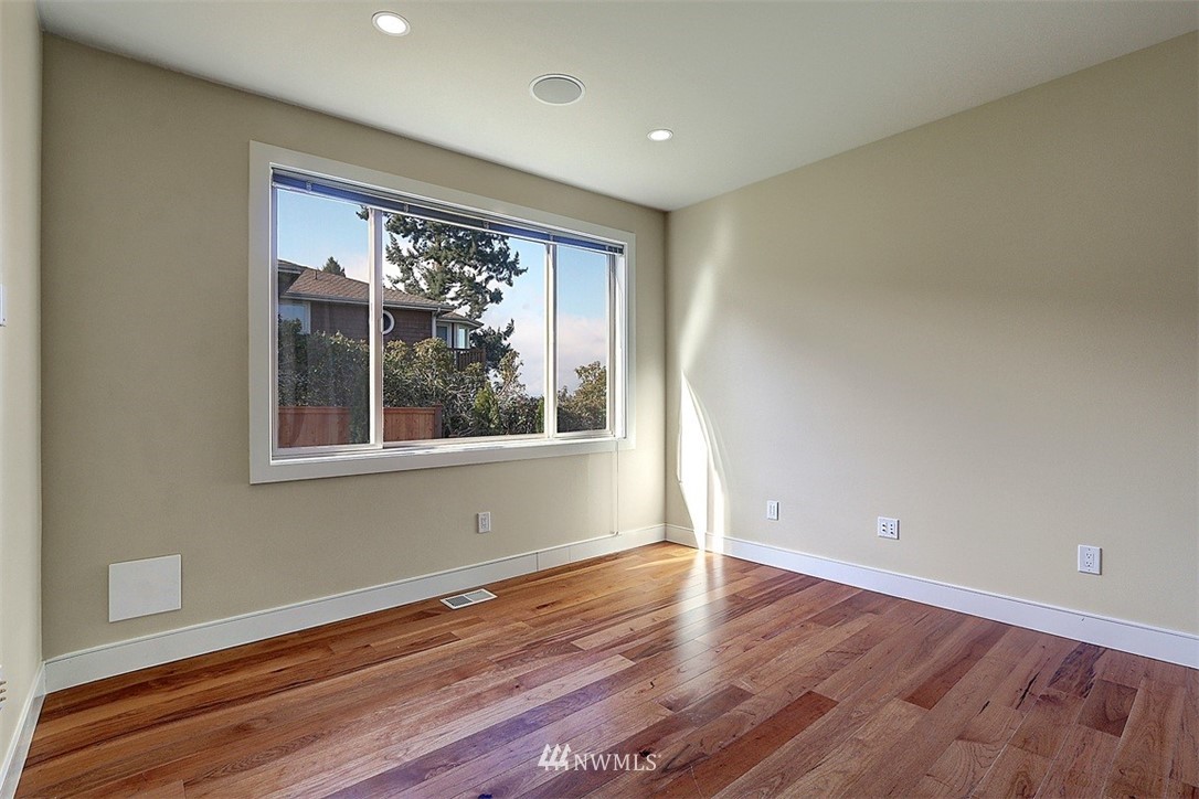 16912 Talbot Road Edmonds, WA 98026 - Photo 21 of 40 a view of an empty room with wooden floor and a window