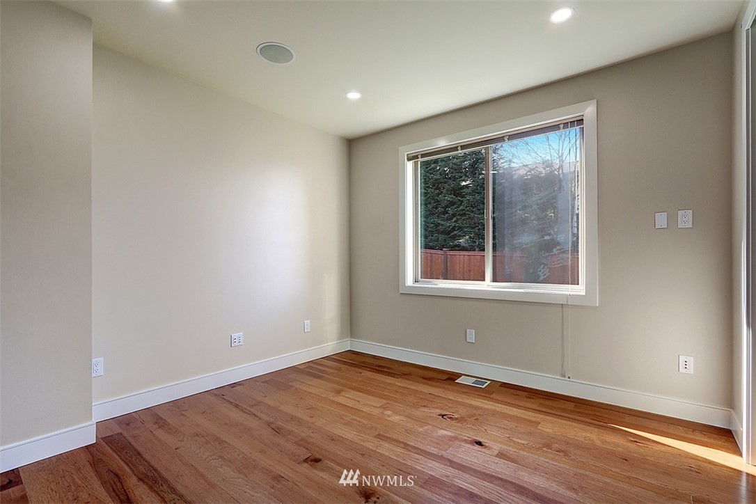 16912 Talbot Road Edmonds, WA 98026 - Photo 22 of 40 an empty room with wooden floor and windows