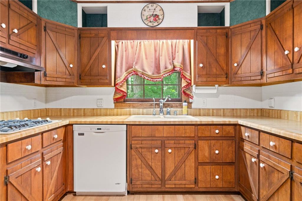 1996 Thomas Road Canton, GA 30115 - Photo 11 of 48 a kitchen with stainless steel appliances granite countertop a sink and a microwave