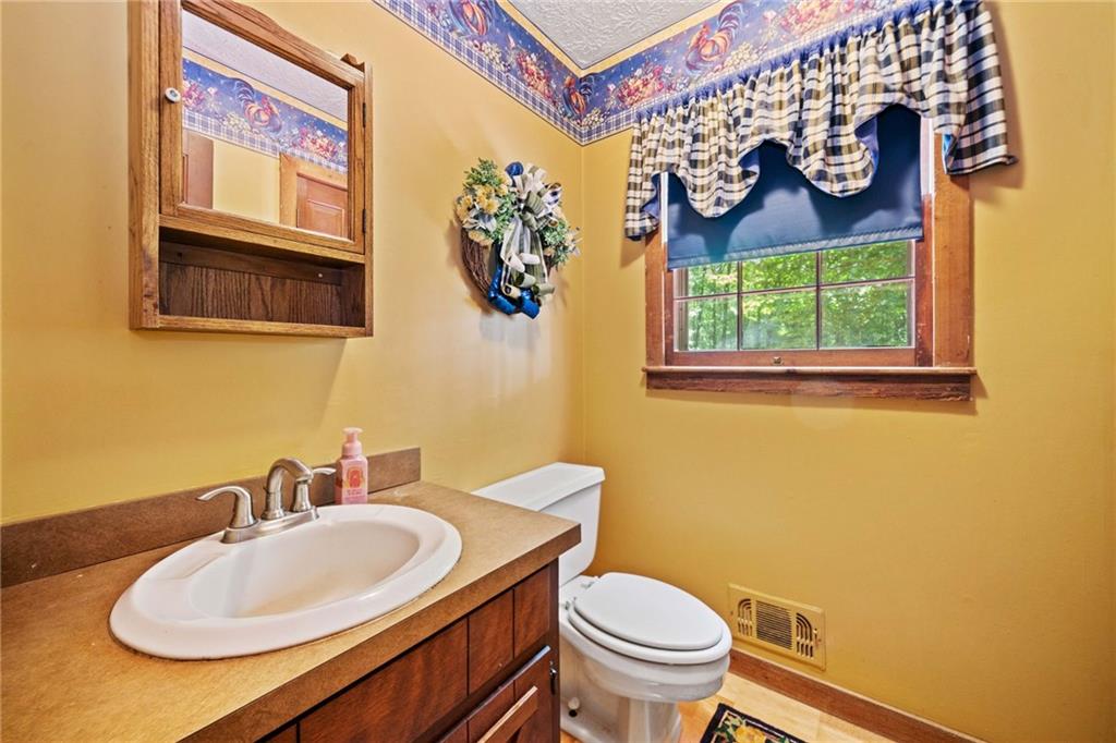 1996 Thomas Road Canton, GA 30115 - Photo 14 of 48 a bathroom with a granite countertop sink and a mirror