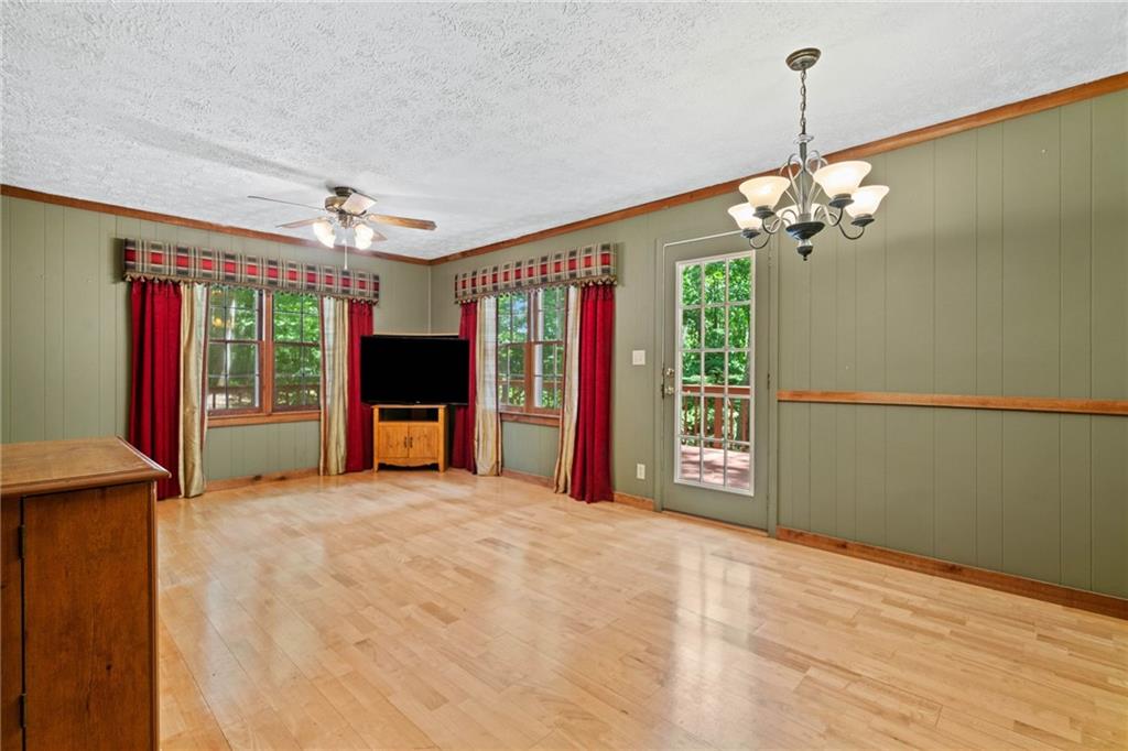 1996 Thomas Road Canton, GA 30115 - Photo 15 of 48 a view of a livingroom with a chandelier fan and windows