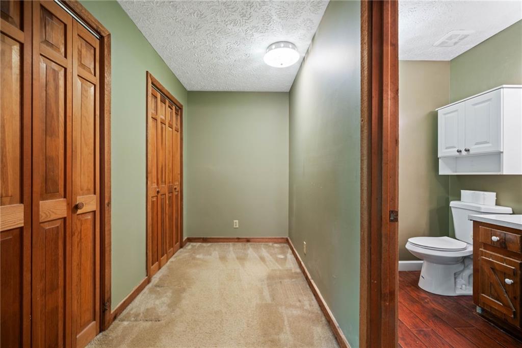 1996 Thomas Road Canton, GA 30115 - Photo 19 of 48 a bathroom with a toilet and a shower