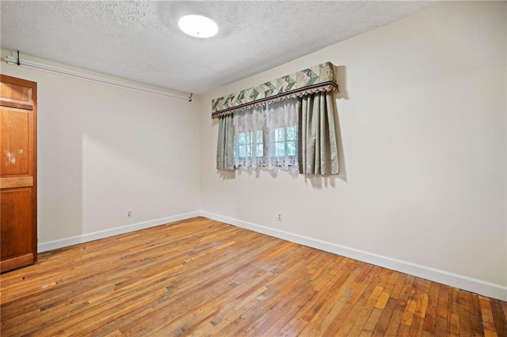1996 Thomas Road Canton, GA 30115 - Photo 22 of 48 an empty room with wooden floor and windows