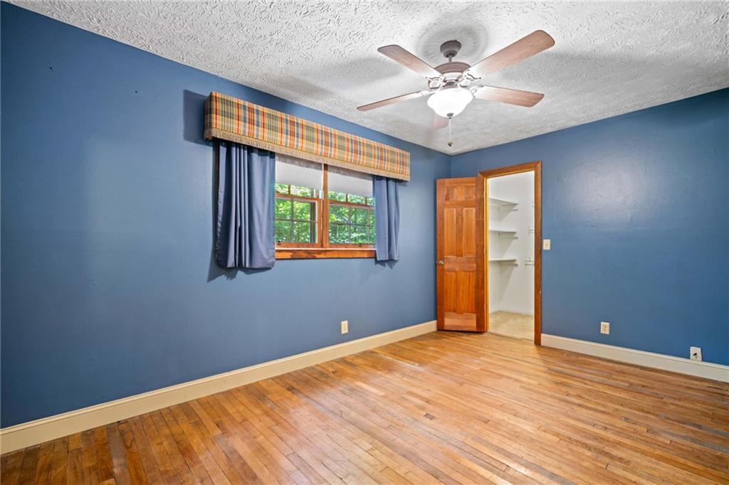 1996 Thomas Road Canton, GA 30115 - Photo 24 of 48 wooden floor in an empty room with a window
