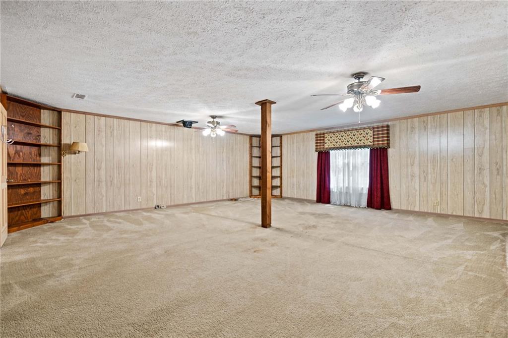 1996 Thomas Road Canton, GA 30115 - Photo 27 of 48 an empty room with windows and fan