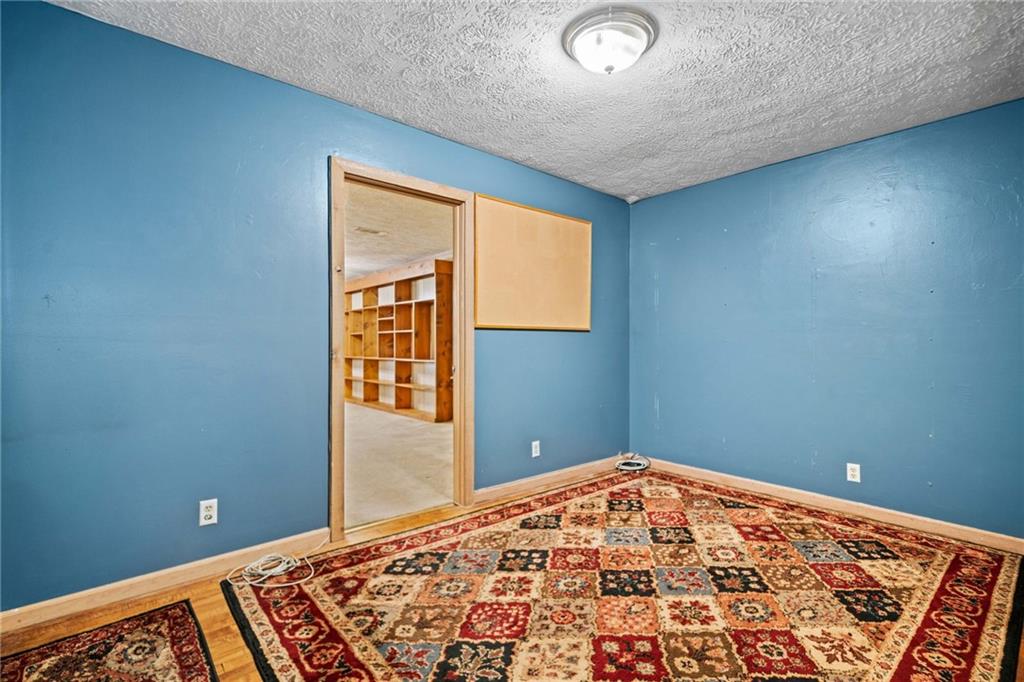 1996 Thomas Road Canton, GA 30115 - Photo 28 of 48 a view of a big room with wooden floor and a chandelier fan