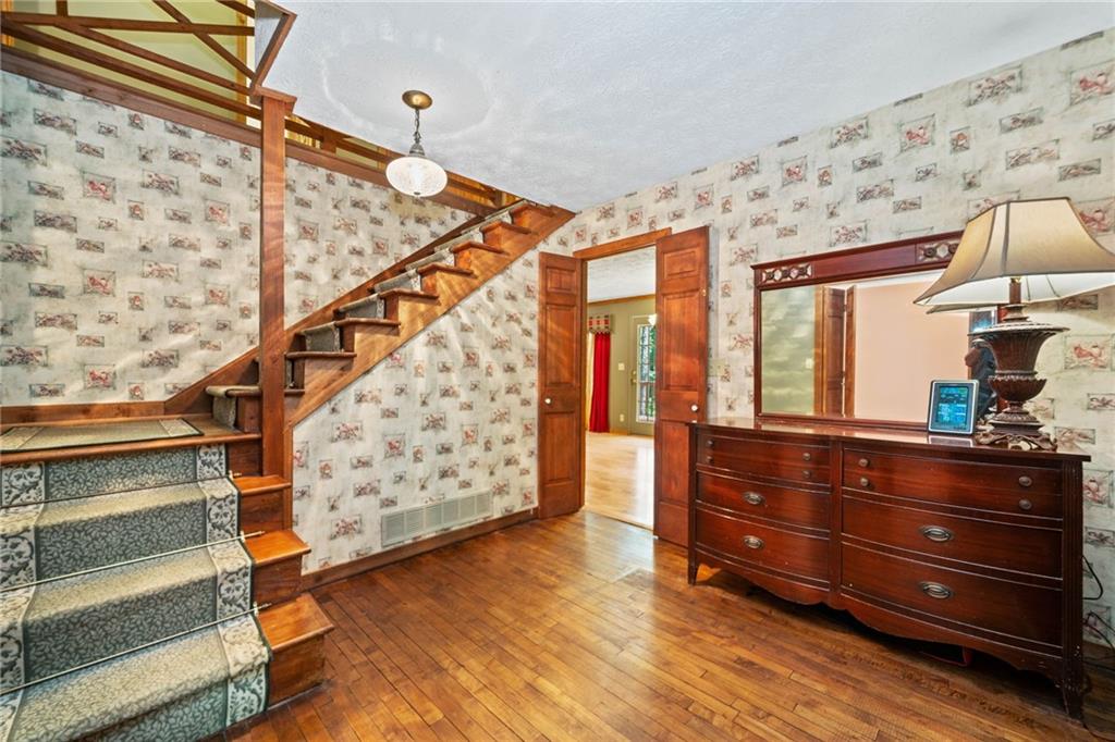 1996 Thomas Road Canton, GA 30115 - Photo 4 of 48 a view of room with wooden floor and staircase