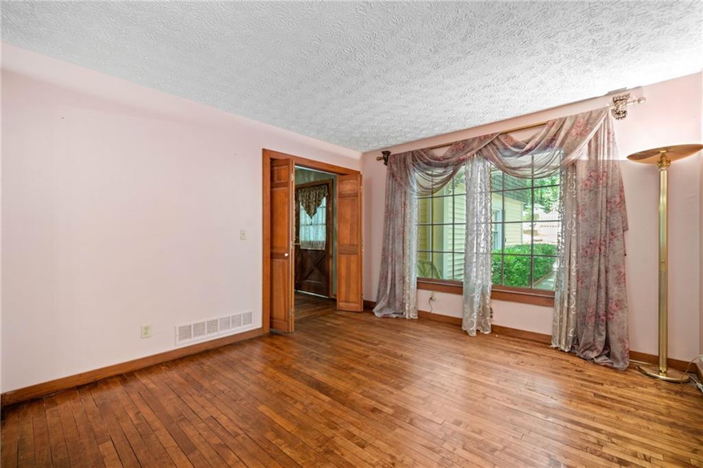1996 Thomas Road Canton, GA 30115 - Photo 5 of 48 an empty room with wooden floor and windows