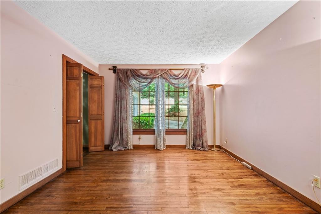 1996 Thomas Road Canton, GA 30115 - Photo 6 of 48 wooden floor in an empty room with a window