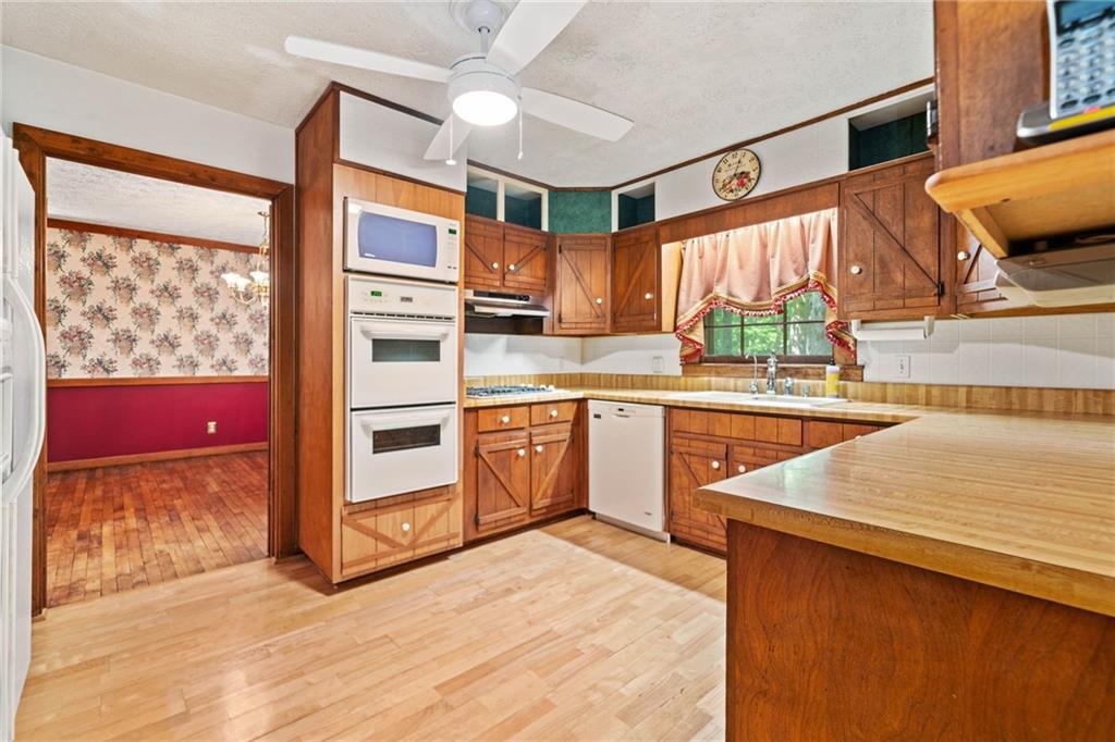 1996 Thomas Road Canton, GA 30115 - Photo 9 of 48 a kitchen with stainless steel appliances granite countertop a sink and a stove next to a window