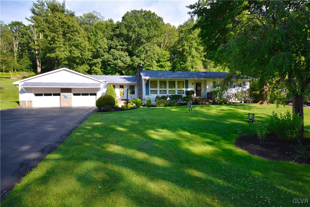 2555 Chase Road Shavertown, PA 18708 - Photo 1 of 21 a patio with a table and chairs under an umbrella