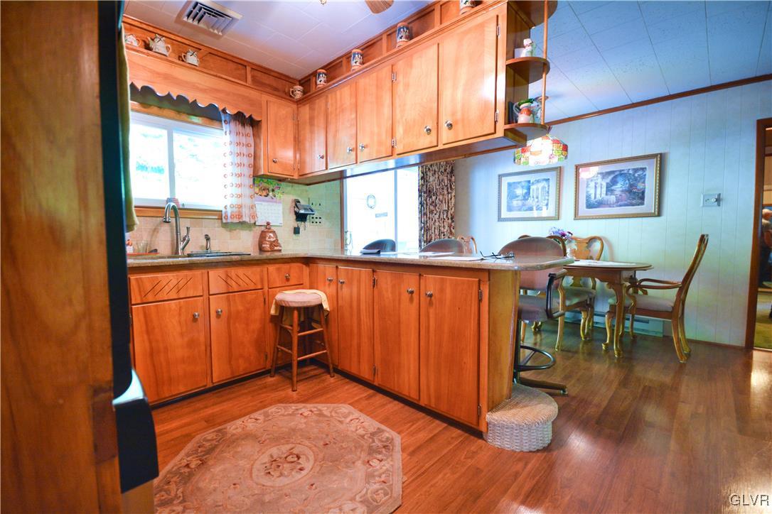 2555 Chase Road Shavertown, PA 18708 - Photo 6 of 21 a view of a kitchen with kitchen island granite countertop wooden floors and a large window
