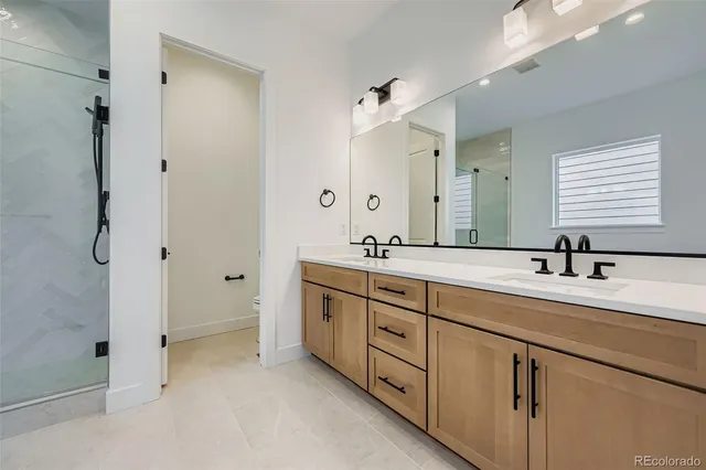 a bathroom with a granite countertop sink mirror and double