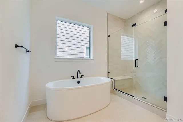 a white bath tub sitting next to a shower