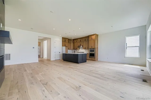 a view of empty room with a fireplace and cabinet
