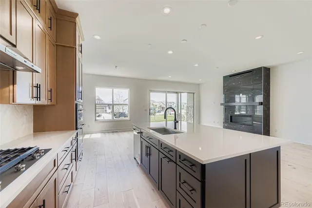 a kitchen with granite countertop a stove and a sink