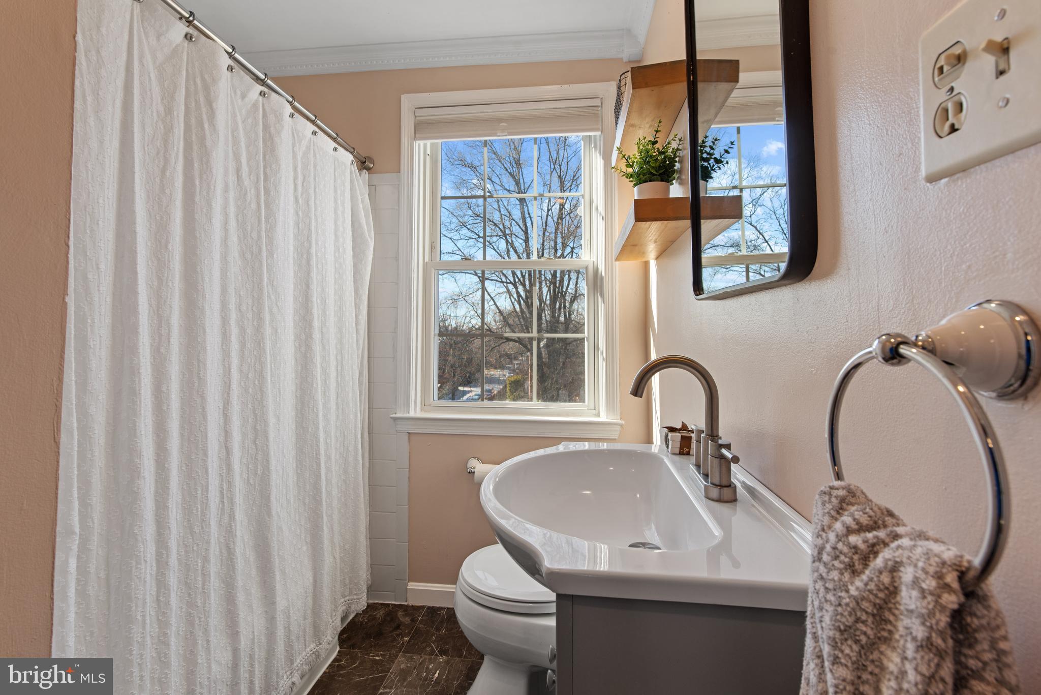 330 Dumbarton Road Baltimore, MD 21212 - Photo 21 of 29 a bathroom with a toilet sink and mirror
