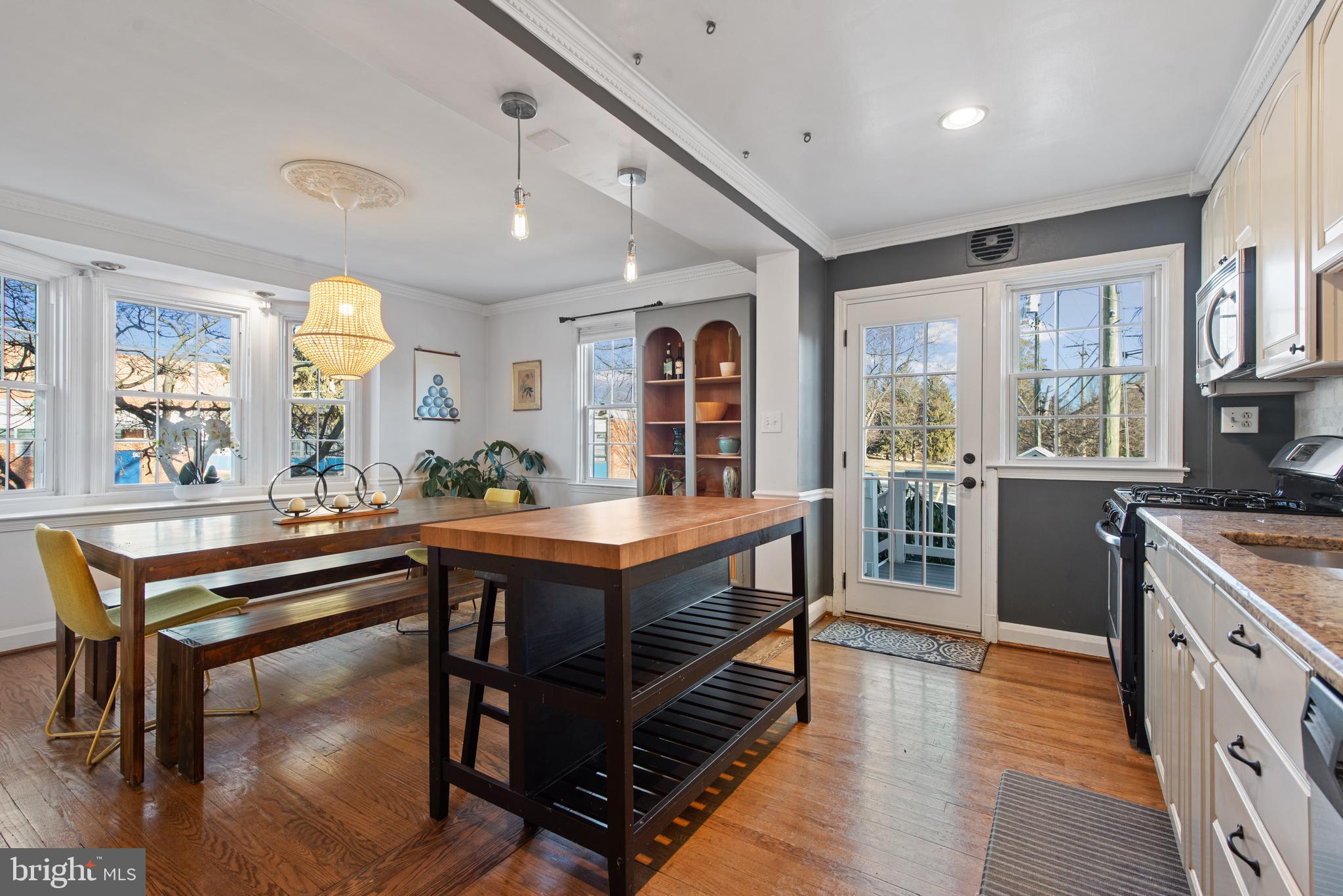 330 Dumbarton Road Baltimore, MD 21212 - Photo 9 of 29 a room with stainless steel appliances granite countertop a stove a sink dishwasher and a dining table with wooden floor
