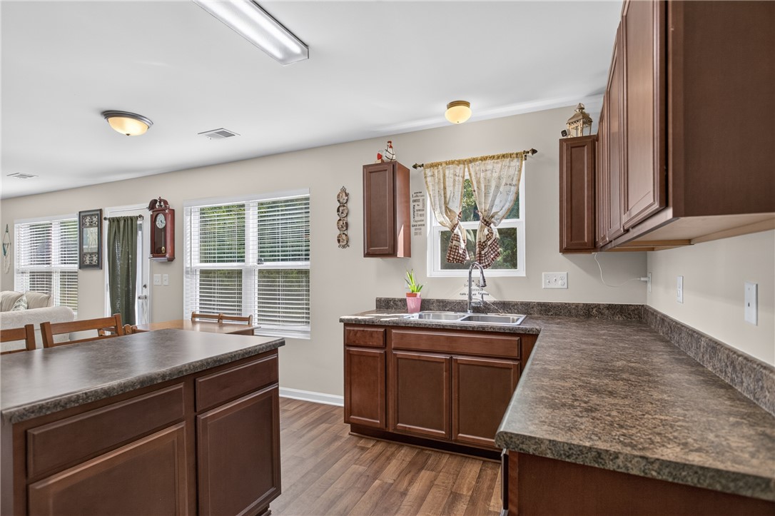 1081 Edenbrooke Circle Anderson, SC 29621 - Photo 10 of 46 Ample counter space and rich cabinetry define this practical kitchen, flowing seamlessly into the adjacent living area.