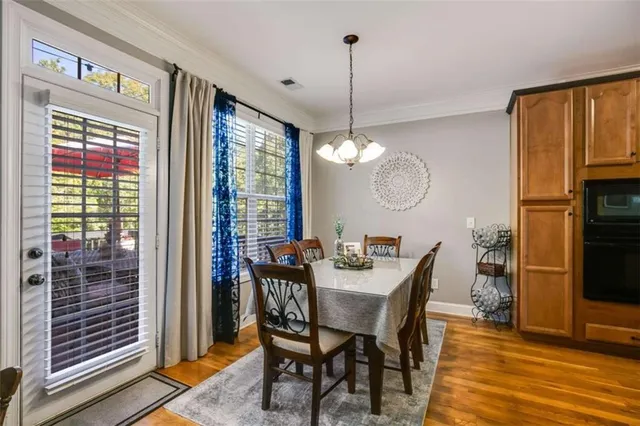 a kitchen with stainless steel appliances granite countertop a sink a stove and cabinets